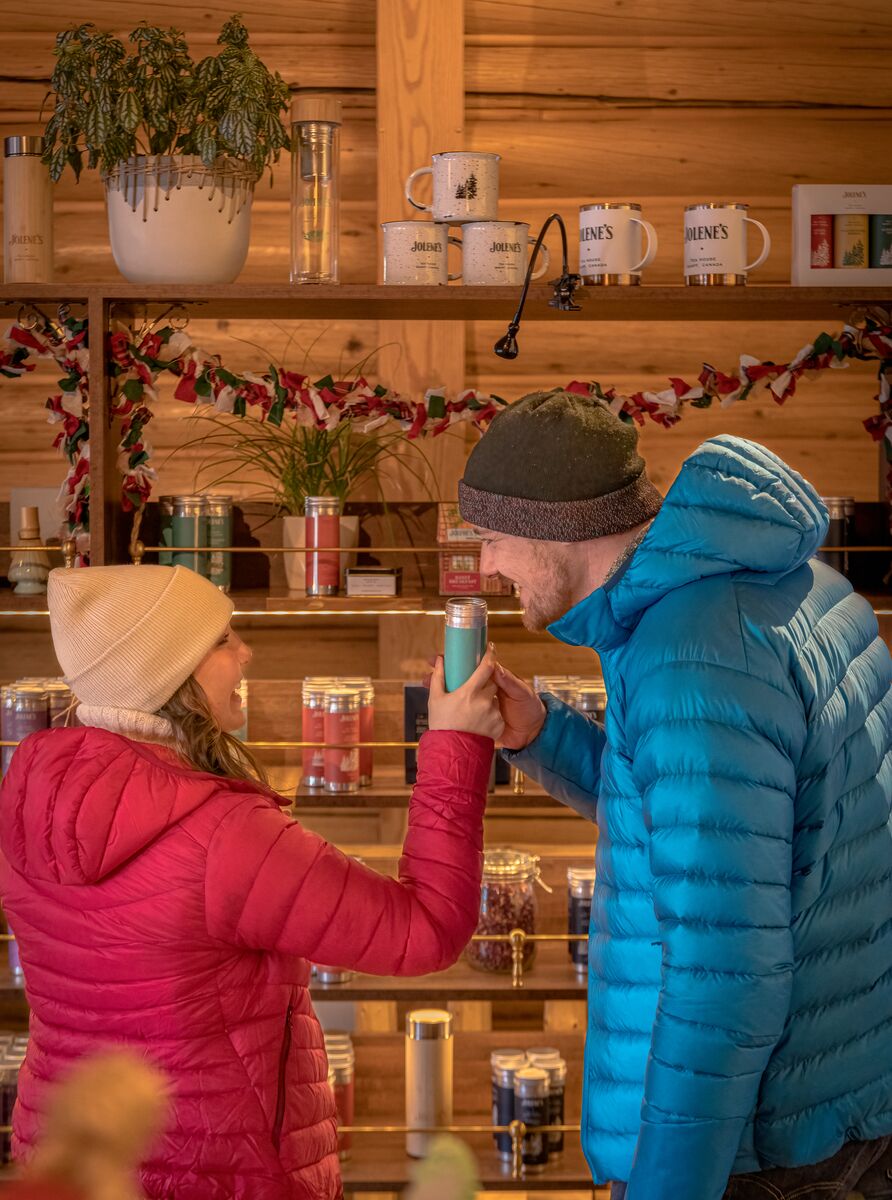 A couple smells a tea at Jolene's Tea House on Bear Street in the Banff Townsite.